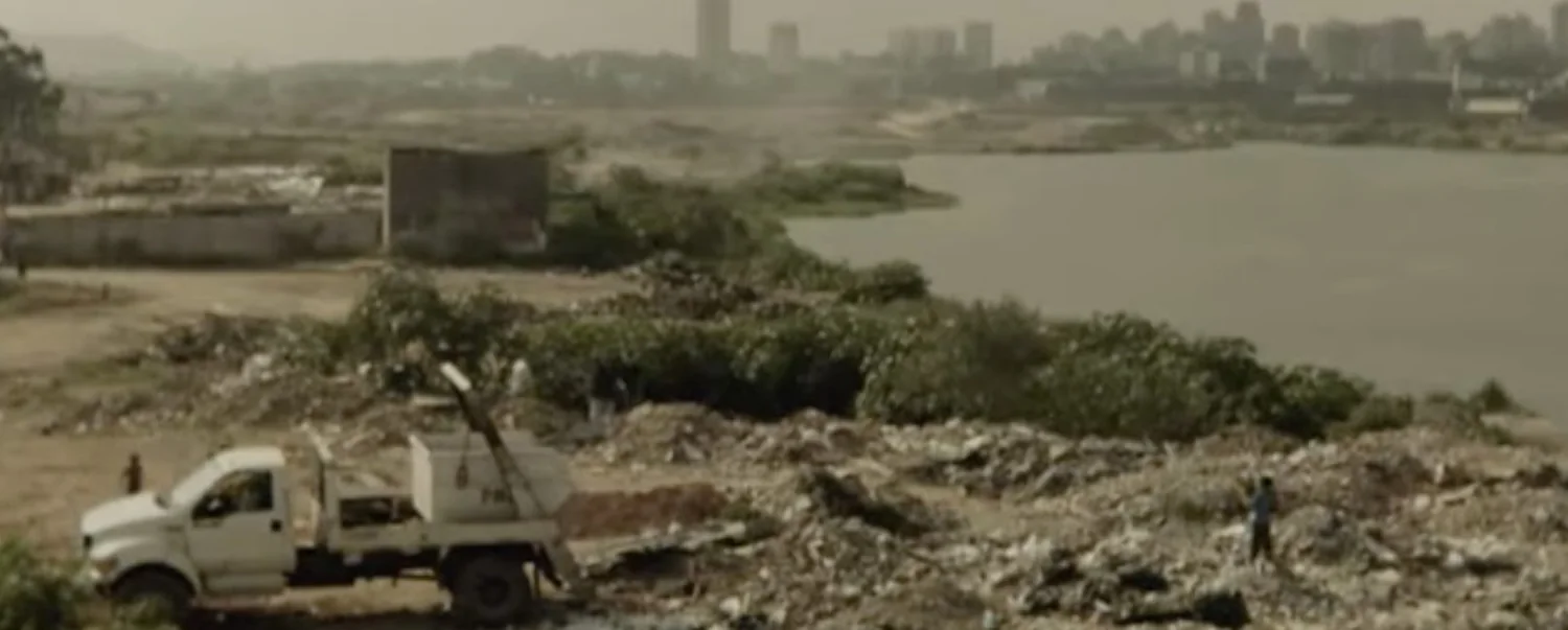 Aerial documentary view of the landfill, lake and São Paulo skyline